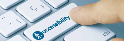 finger pressing a keyboard button that says accessibility
